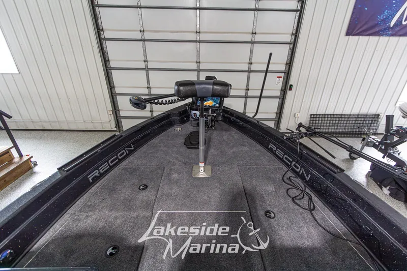Slide: The Image of 2027 Recon 985 DC boat interior at Lakeside Marina, featuring advanced navigation equipment. - 27