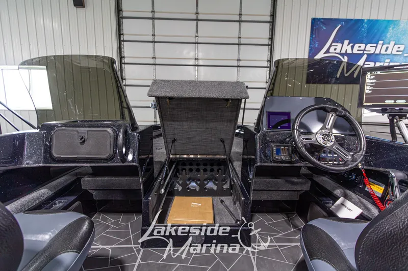 Slide: The Image of Interior of a 2027 Recon 985 DC boat at Lakeside Marina, featuring modern controls and storage. - 26