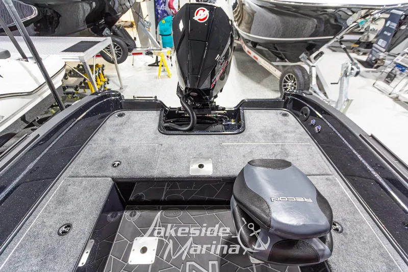Slide: The Image of 2027 Recon 985 DC boat interior with motor, displayed at Lakeside Marina. - 16