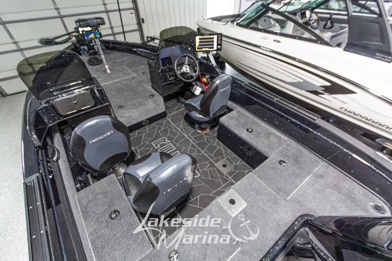 Slide: The Image of Interior of a 2027 Recon 985 DC boat with modern seating and control panel. - 15