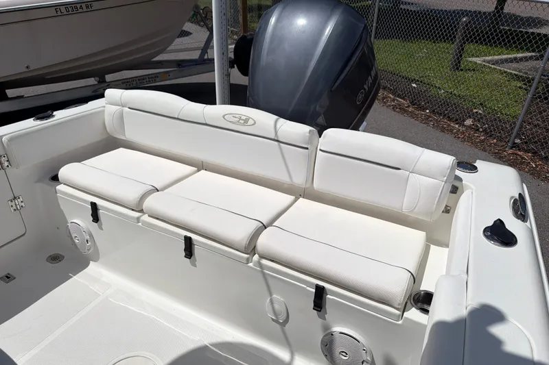 Slide: The Image of 2017 Sea Hunt Ultra 235SE boat with white cushioned seating and Yamaha outboard motor. - 6