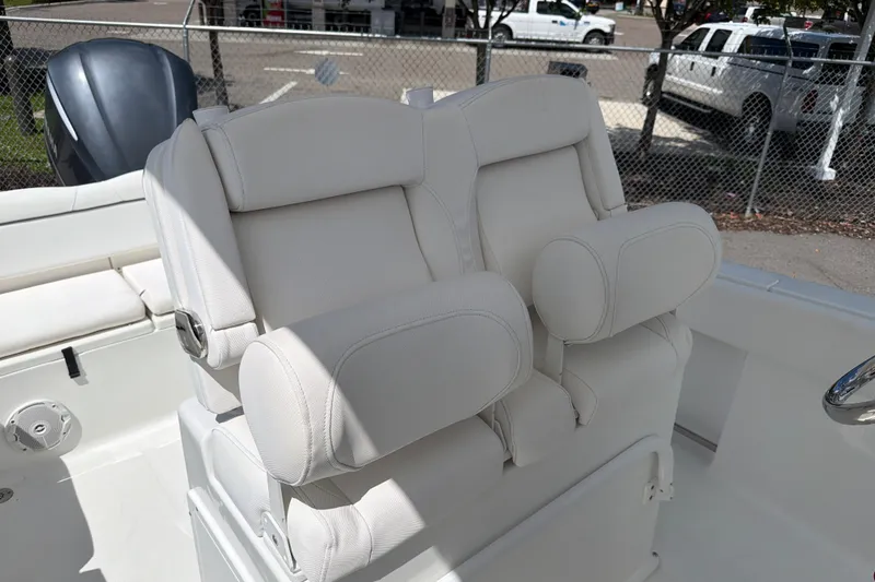 Slide: The Image of 2017 Sea Hunt Ultra 235SE boat with plush white seating and steering wheel. - 8