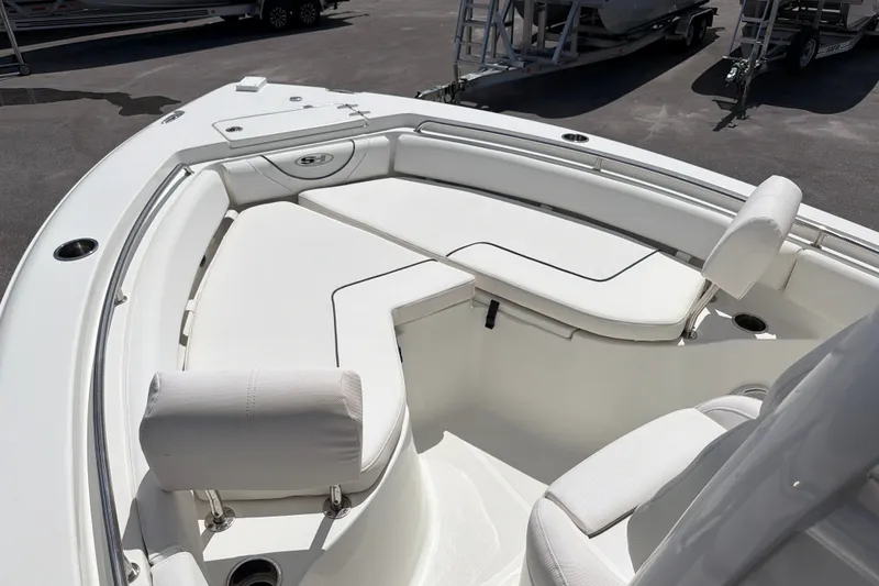 Slide: The Image of 2017 Sea Hunt Ultra 235SE boat with white cushioned seating and sleek design. - 12