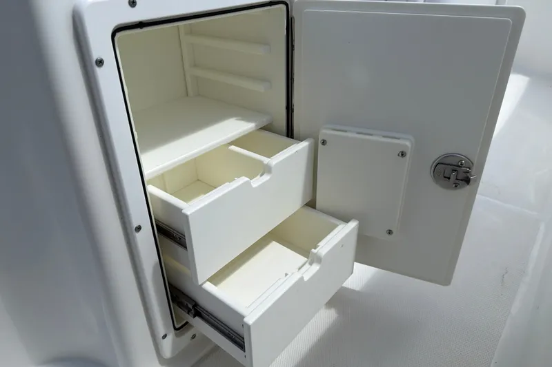 Slide: The Image of Storage compartment with drawers on a 2017 Sea Hunt Ultra 235SE boat. - 10