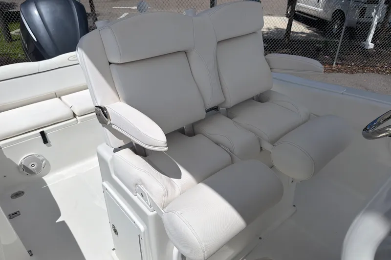 Slide: The Image of 2017 Sea Hunt Ultra 235SE boat with plush white seating and armrests. - 7