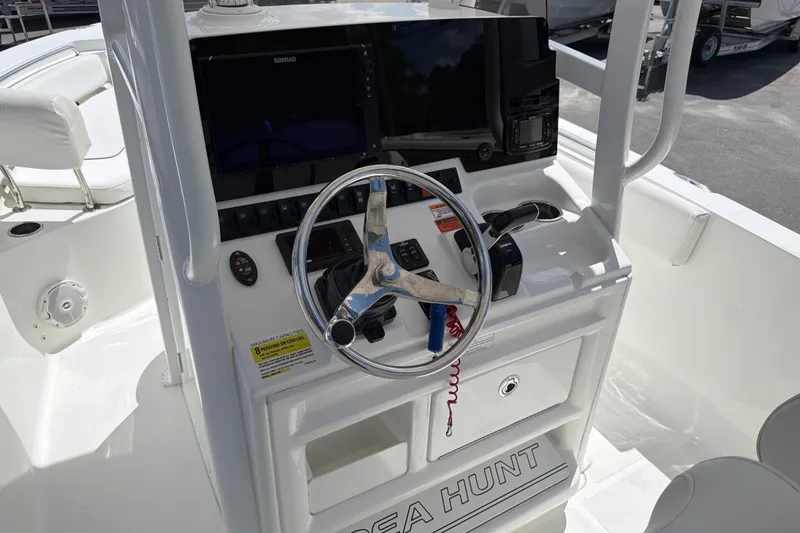 Slide: The Image of 2017 Sea Hunt Ultra 235SE boat console with steering wheel and navigation equipment. - 9