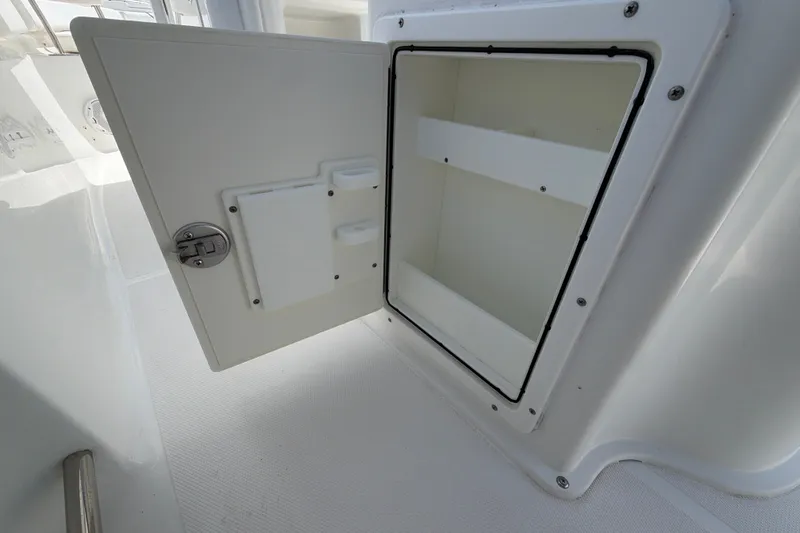 Slide: The Image of Open storage compartment on a 2017 Sea Hunt Ultra 235SE boat. - 11