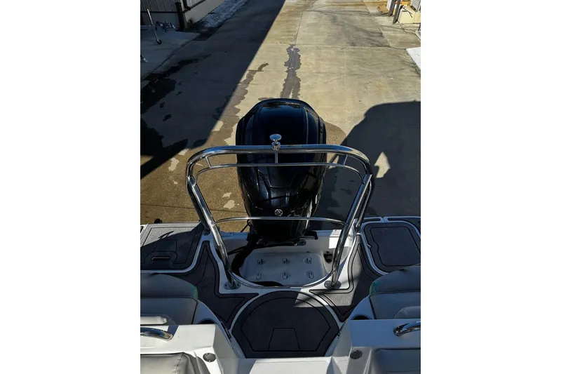 Slide: The Image of 2024 Hurricane SunDeck 2486 OB boat with sleek outboard motor and stylish deck design. - 6