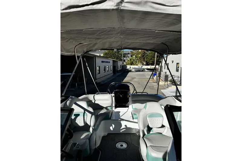 Slide: The Image of 2024 Hurricane SunDeck 2486 OB boat interior with canopy and seating. - 8