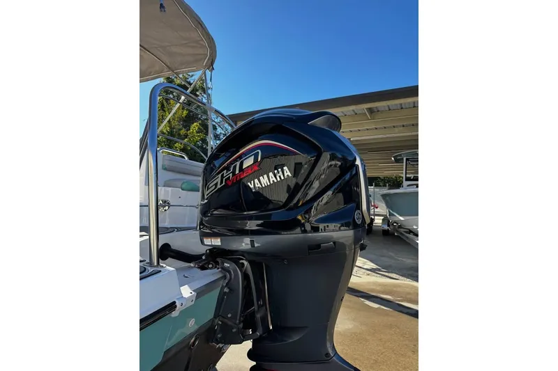 Slide: The Image of 2024 Hurricane SunDeck 2486 OB with Yamaha outboard motor in marina setting. - 3