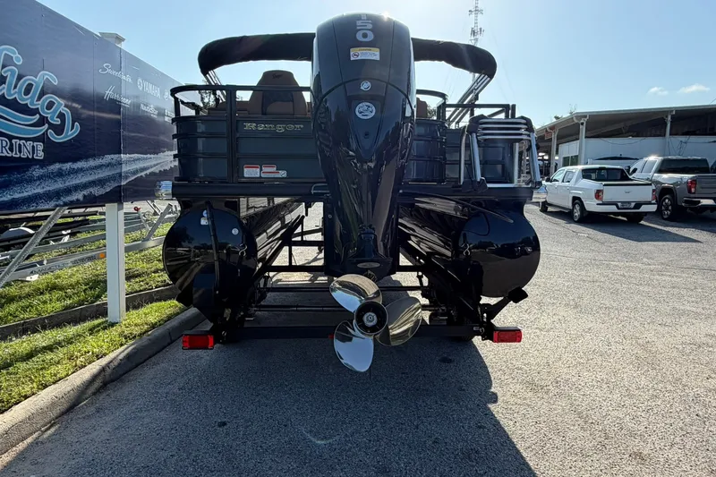 Slide: The Image of Ranger 220FC 2027 boat with powerful outboard motor, parked at a marina. - 26