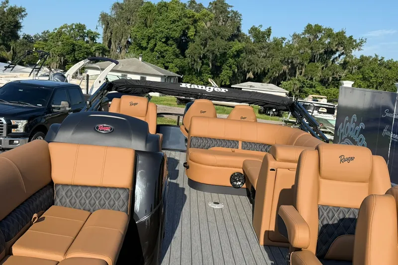 Slide: The Image of Luxurious 2027 Ranger 220FC boat with tan leather seating and sleek design. - 5