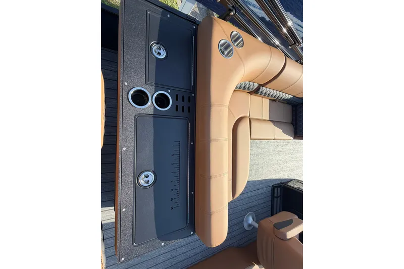 Slide: The Image of Luxurious seating and console on 2027 Ranger 220FC boat, featuring cup holders and sleek design. - 20