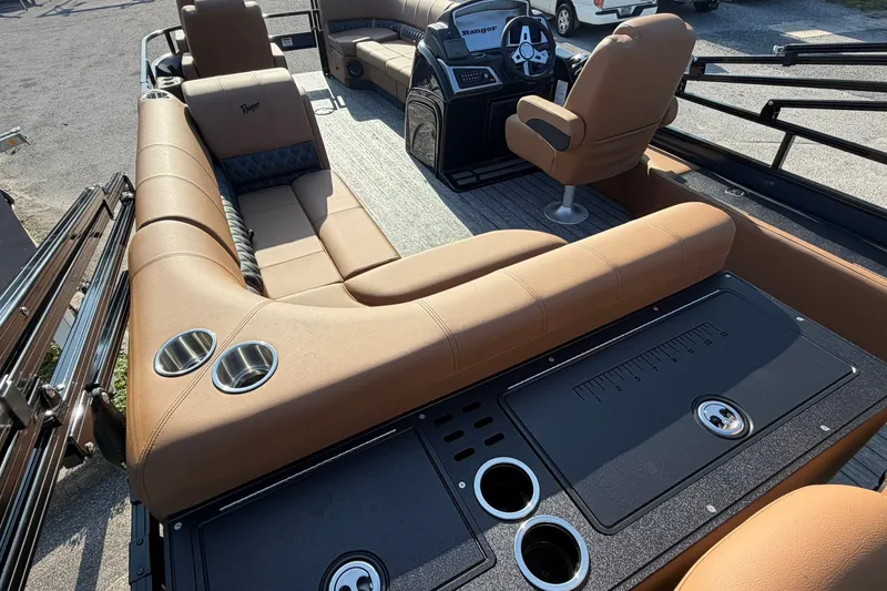 Slide: The Image of Luxurious interior of 2027 Ranger 220FC boat with tan seating and modern dashboard. - 16