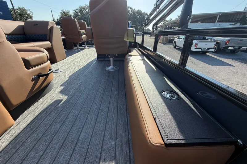 Slide: The Image of 2027 Ranger 220FC boat interior with brown seating and storage compartments. - 22