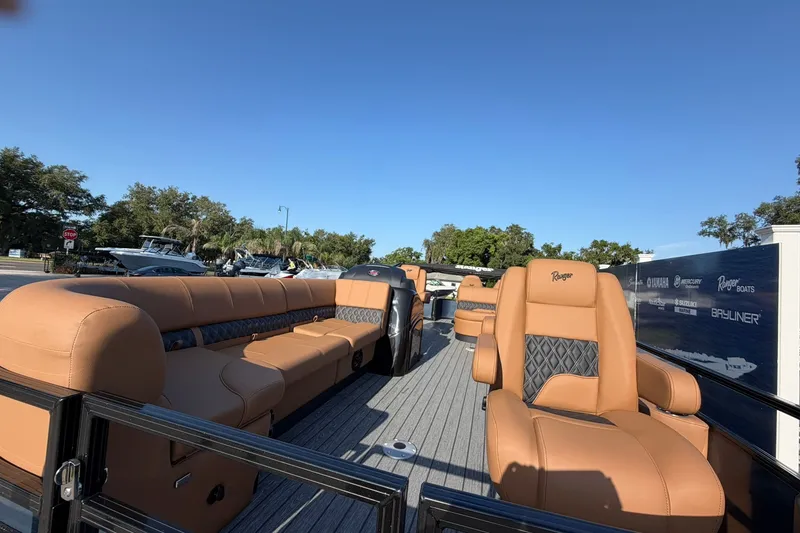 Slide: The Image of 2027 Ranger 220FC boat with luxurious tan seating and sleek design. - 2