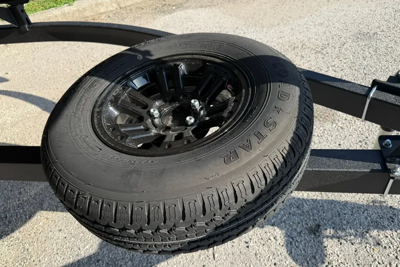 Slide: The Image of Spare tire mounted on a Ranger 220FC trailer, 2027 model, on a sunny day. - 31