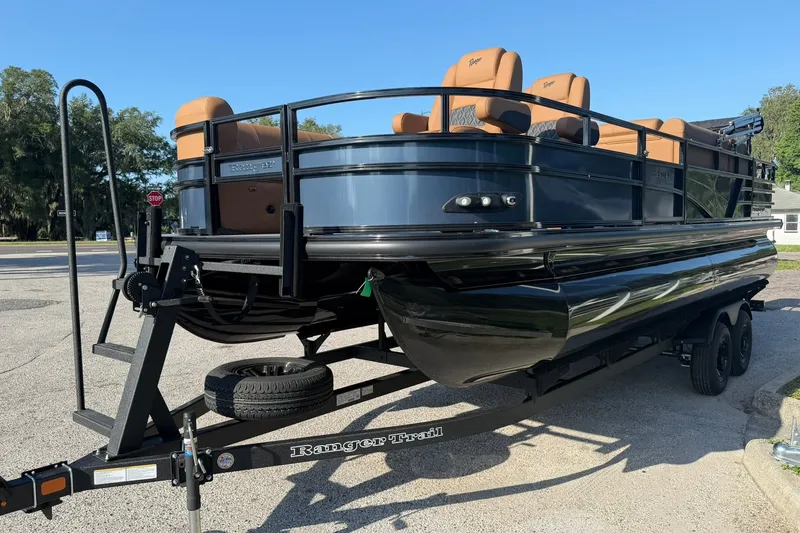 Slide: The Image of 2027 Ranger 220FC pontoon boat on trailer, featuring sleek design and tan seating. - 30