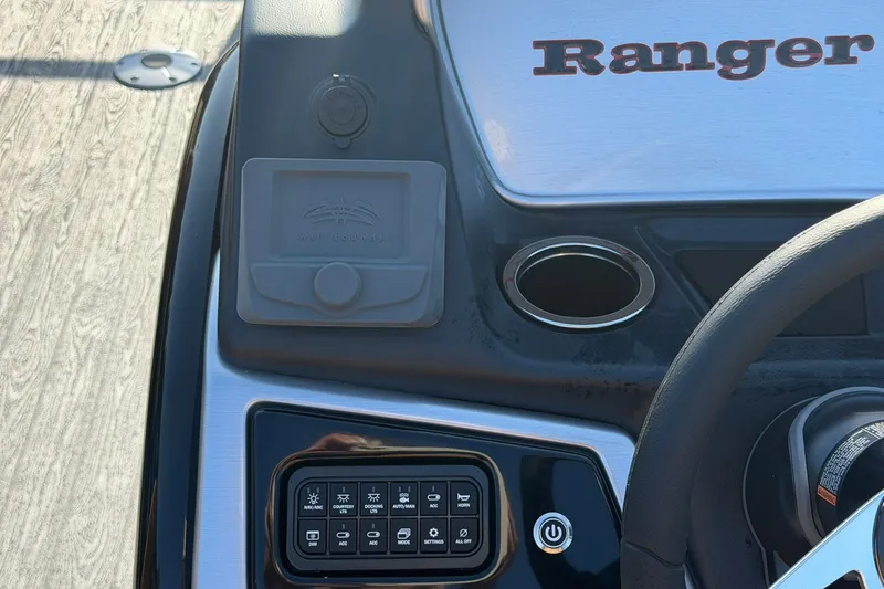 Slide: The Image of Dashboard of a 2027 Ranger 220FC boat with control panel and cup holder. - 13