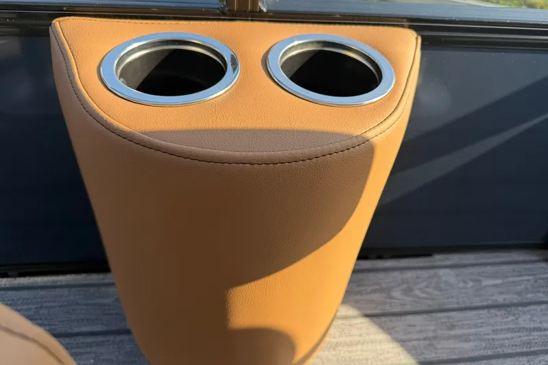 Slide: The Image of Cup holders in tan leather interior of 2027 Ranger 220FC boat. - 7