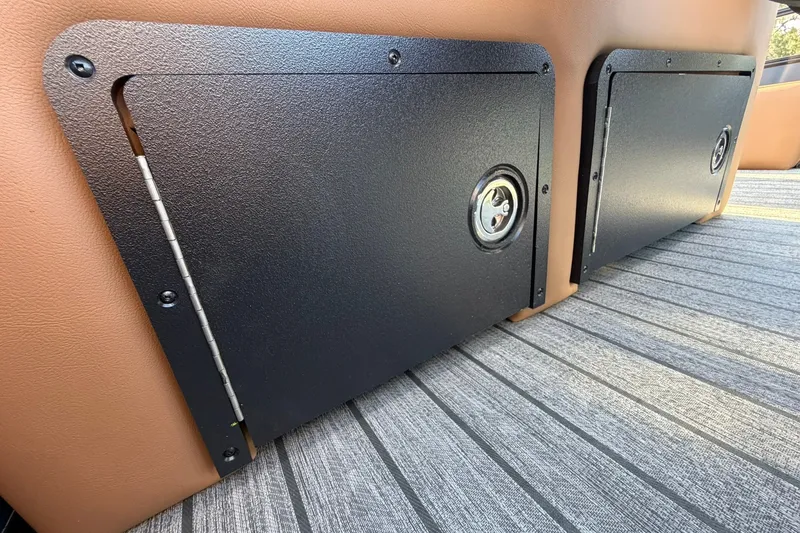 Slide: The Image of 2027 Ranger 220FC storage compartments with secure locks on a striped floor. - 21
