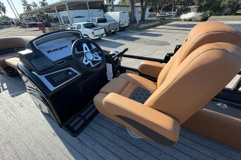 Slide: The Image of Ranger 220FC 2027 boat helm with tan captain's chair and steering wheel. - 11