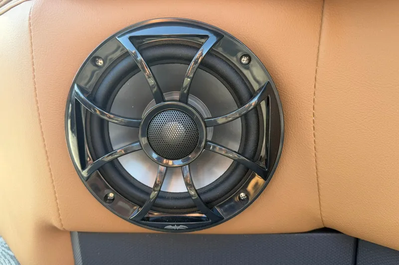 Slide: The Image of Speaker installed in a Ranger 220FC 2027 model, set against tan upholstery. - 23