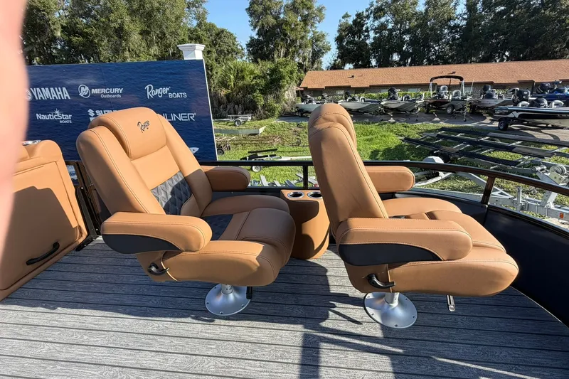 Slide: The Image of Luxurious seating on 2027 Ranger 220FC boat, featuring tan leather chairs and cup holders. - 6