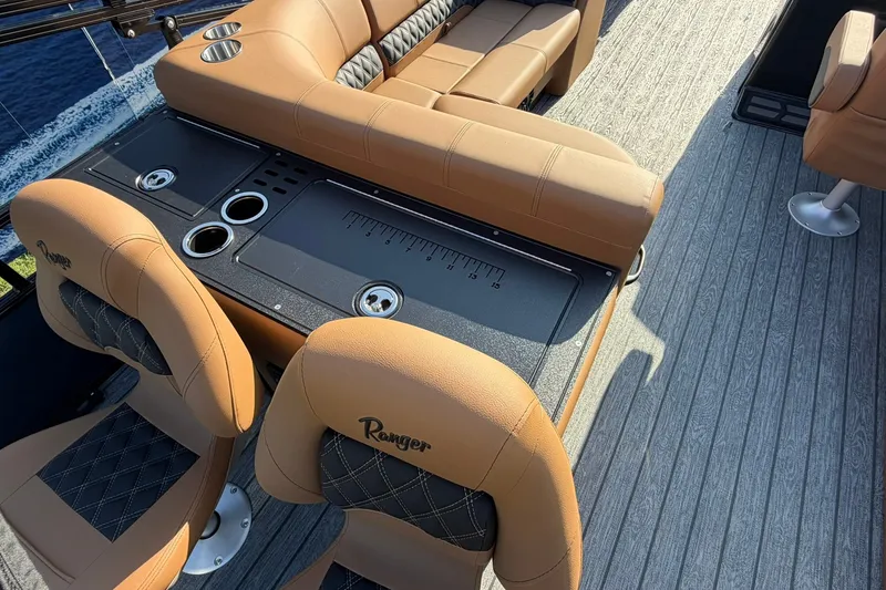 Slide: The Image of Luxurious seating on 2027 Ranger 220FC boat with tan upholstery and cup holders. - 18