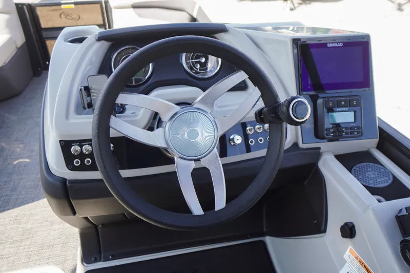 Slide: The Image of 2024 Barletta Cabrio 22UC boat dashboard with steering wheel and navigation system. - 19