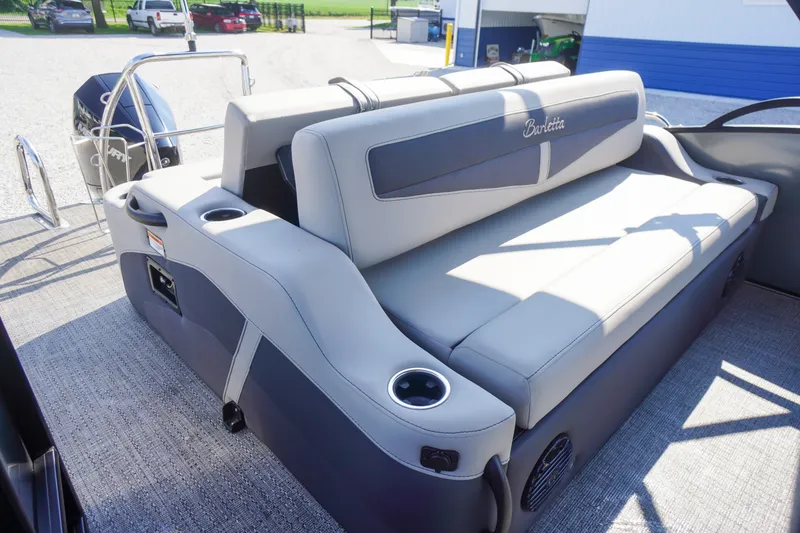Slide: The Image of 2024 Barletta Cabrio 22UC boat interior with plush seating and cup holders. - 39