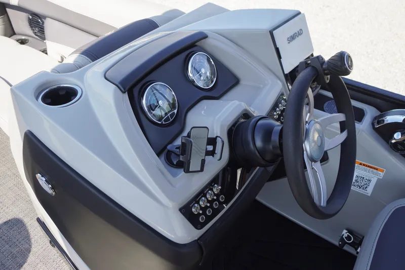 Slide: The Image of 2024 Barletta Cabrio 22UC boat dashboard with steering wheel and gauges. - 15