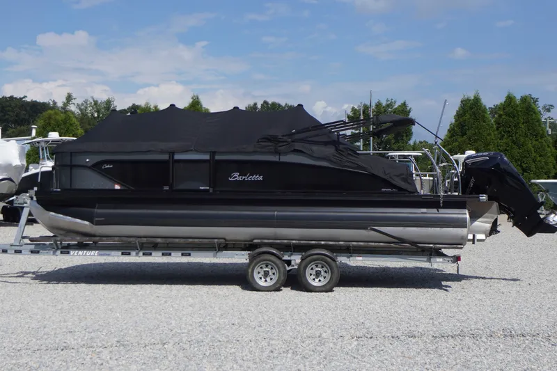 Slide: The Image of 2024 Barletta Cabrio 22UC pontoon boat on trailer, covered and parked outdoors. - 52