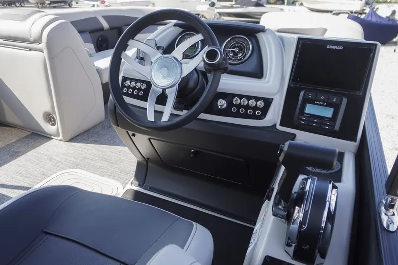 Slide: The Image of 2024 Barletta Cabrio 22UC boat dashboard with steering wheel and control panel. - 14