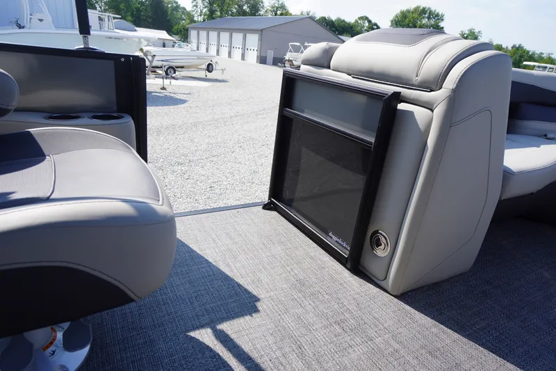 Slide: The Image of 2024 Barletta Cabrio 22UC boat interior with gray seating and storage compartment. - 26