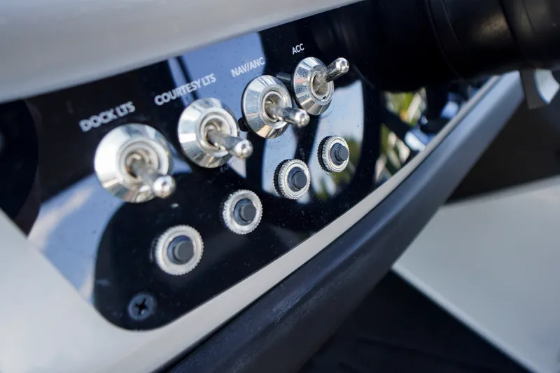 Slide: The Image of Control panel of 2024 Barletta Cabrio 22UC boat with toggle switches. - 18