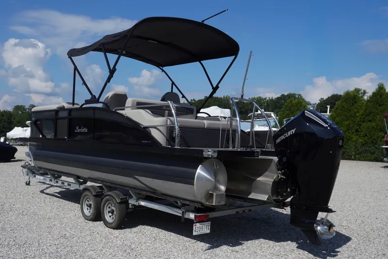 Slide: The Image of 2024 Barletta Cabrio 22UC pontoon boat on trailer, featuring a Mercury outboard motor. - 45