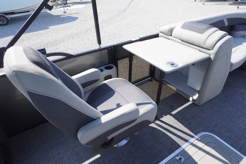 Slide: The Image of 2024 Barletta Cabrio 22UC boat interior with swivel chair and table setup. - 24