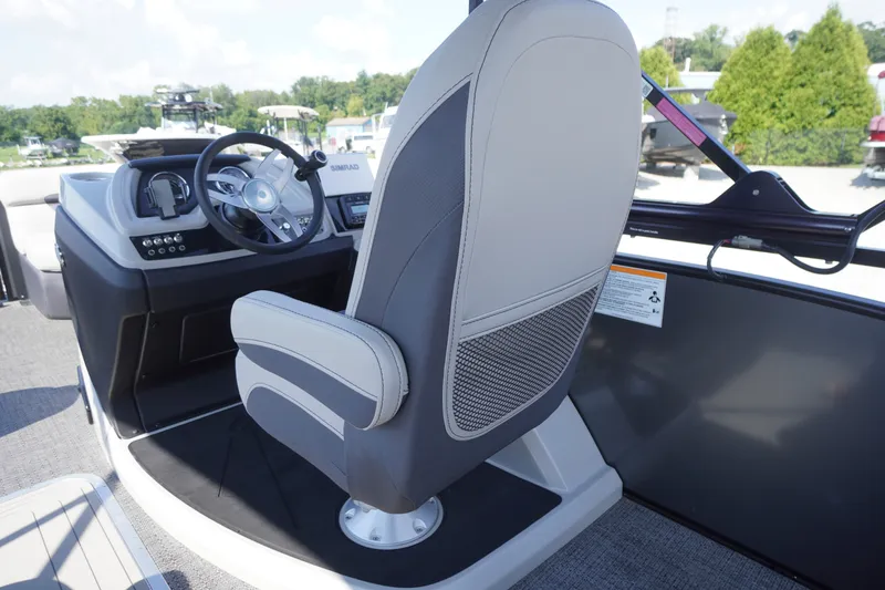 Slide: The Image of 2024 Barletta Cabrio 22UC boat helm with steering wheel and captain's chair. - 29