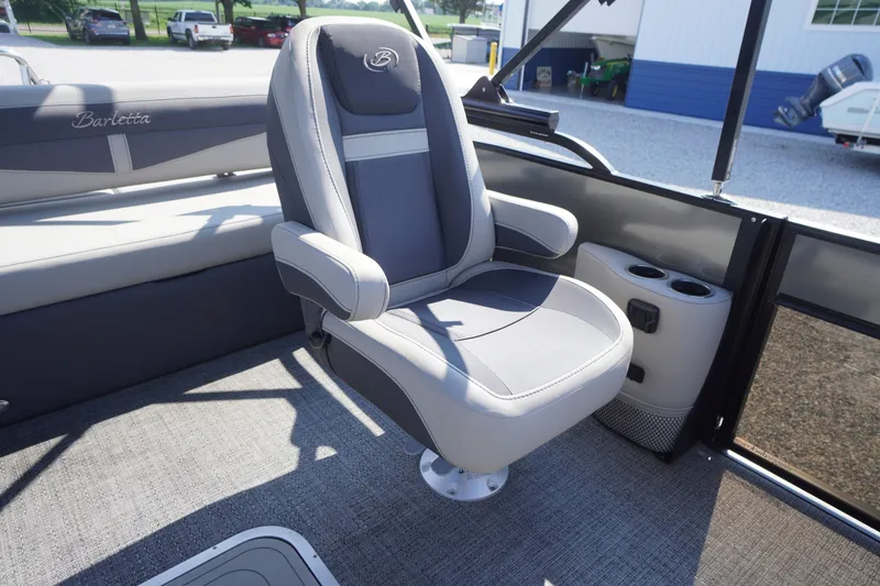 Slide: The Image of 2024 Barletta Cabrio 22UC boat interior with plush captain's chair and cup holders. - 30