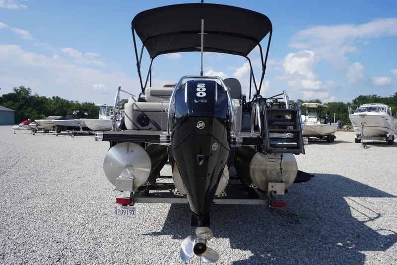 Slide: The Image of 2024 Barletta Cabrio 22UC pontoon boat with 300 V8 engine, parked on gravel lot. - 46