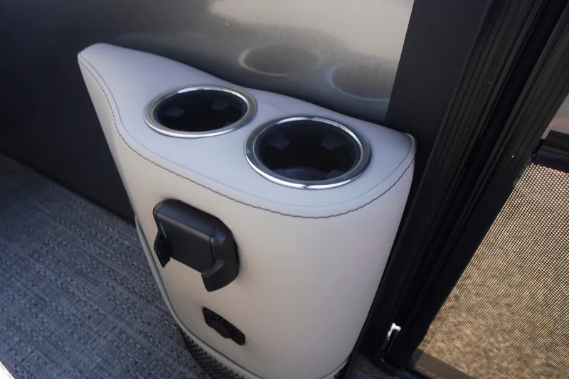 Slide: The Image of 2024 Barletta Cabrio 22UC cup holders and power outlet detail. - 32