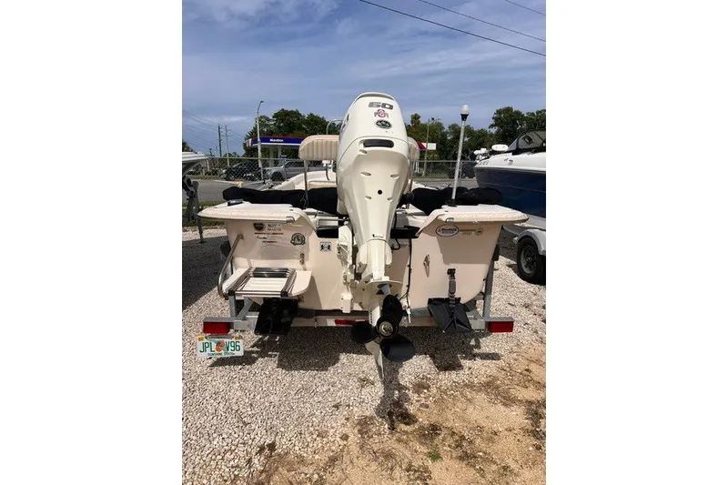 Slide: The Image of 2018 Carolina Skiff 16 JVX CC boat with outboard motor, parked on gravel. - 1