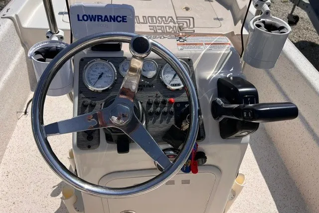 Slide: The Image of 2018 Carolina Skiff 16 JVX CC boat console with steering wheel and controls. - 6