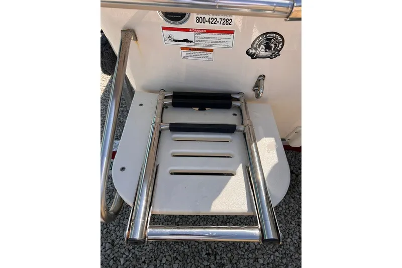 Slide: The Image of 2018 Carolina Skiff 16 JVX CC boat ladder with safety warnings and contact information. - 2