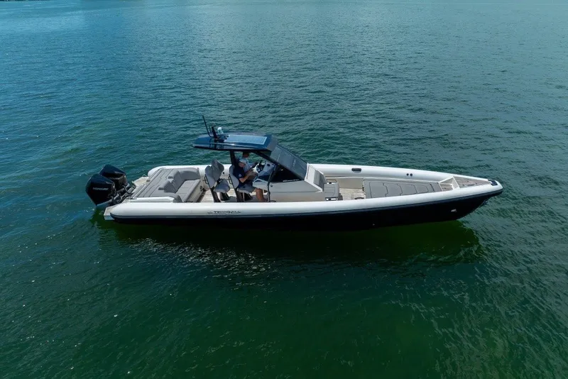 Slide: The Image of 2021 Technohull 38 Grand Sport boat cruising on calm water. - 8