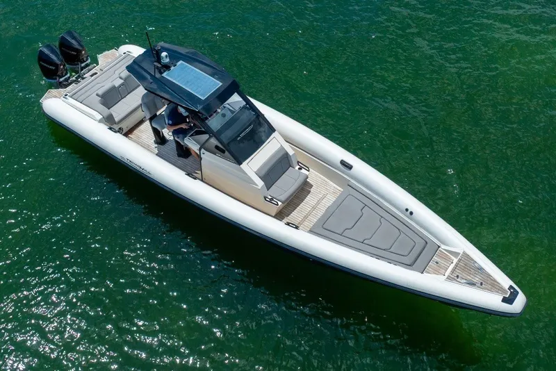 Slide: The Image of 2021 Technohull 38 Grand Sport boat on clear green water, aerial view. - 17