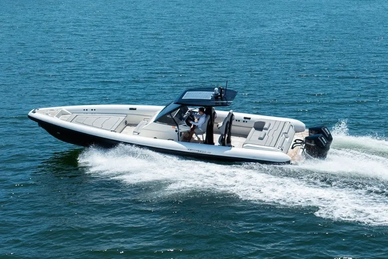 Slide: The Image of 2021 Technohull 38 Grand Sport cruising on open water, showcasing sleek design and performance. - 22