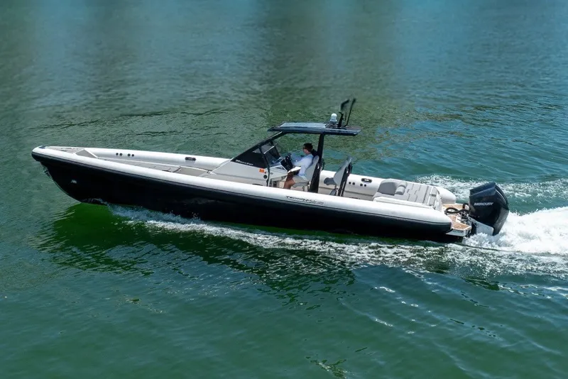 Slide: The Image of 2021 Technohull 38 Grand Sport boat cruising on clear water. - 21