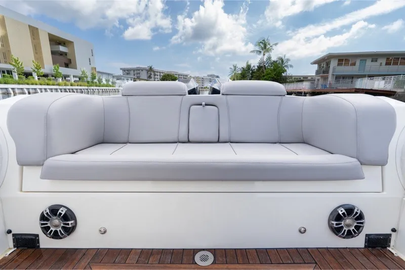 Slide: The Image of Luxury seating on 2021 Technohull 38 Grand Sport boat, docked with modern buildings in background. - 39